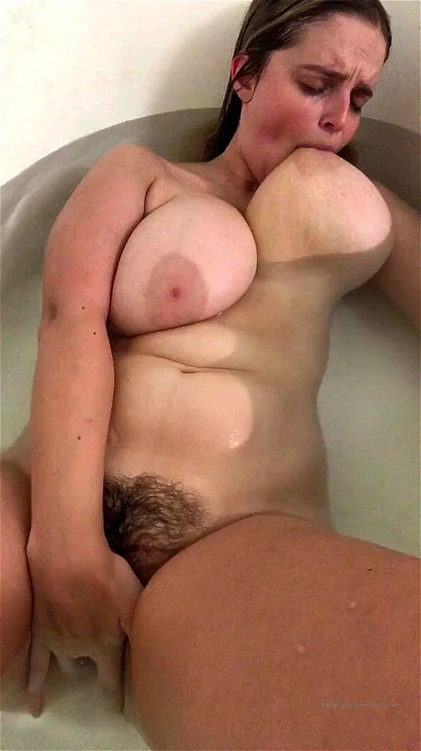 Busty babe playing with her hairy pussy in the shower