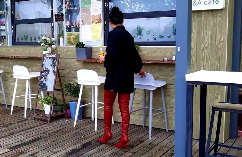 Oriental lady in brown thigh high boots at the cafe