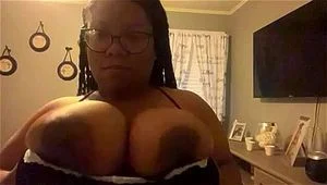 Ebony playing with big tits