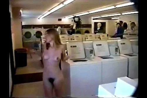 blonde nudist walks around naked at Laundromat