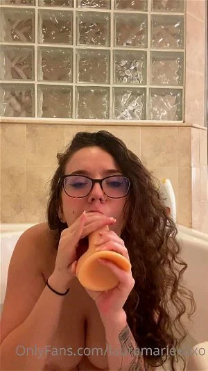 Busty babe getting herself wet in bathtub