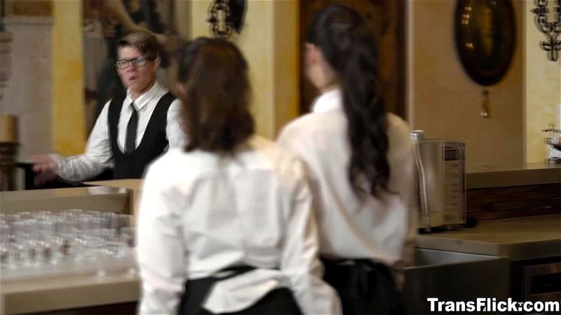 Two caterers caressing each other just out of view of their boss