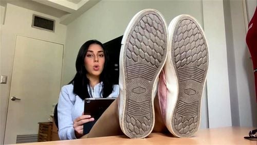 Latina shows feet while reading