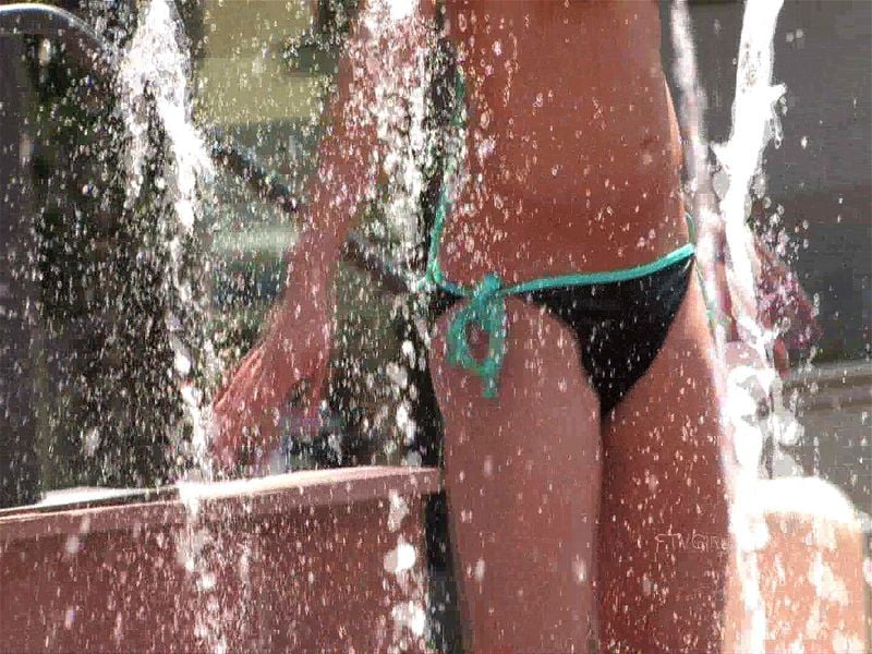 Playing in a public water fountain.