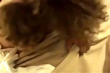 Two girls pull the sheets off the bed while making love