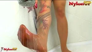 Redhead masturbates while taking a shower in pantyhose