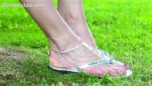 Linda in shiny sandals and foot jewelry