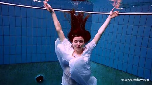Redhead Marketa in a white dress in the pool