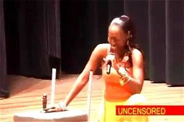 african woman comedian deep throats a dildo