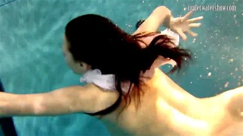 Brunette big tits teen Andrea swimming in the pool