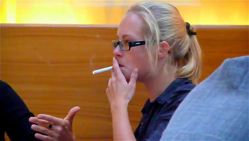 confident blond smoking in a meeting