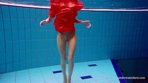 Cute babe in red sexy open dress swimming