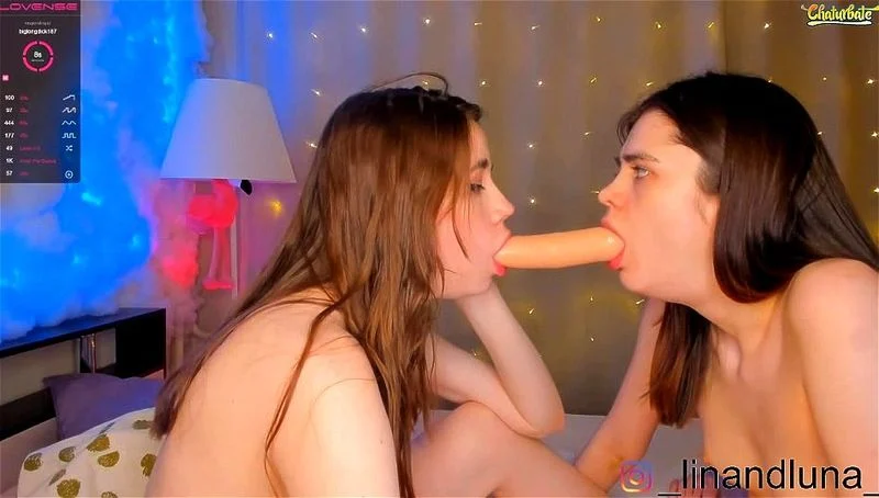 Lesbian teens sucking a double headed dildo on cam