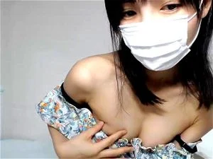 Petite Japanese babe teases with her small tits on livechat