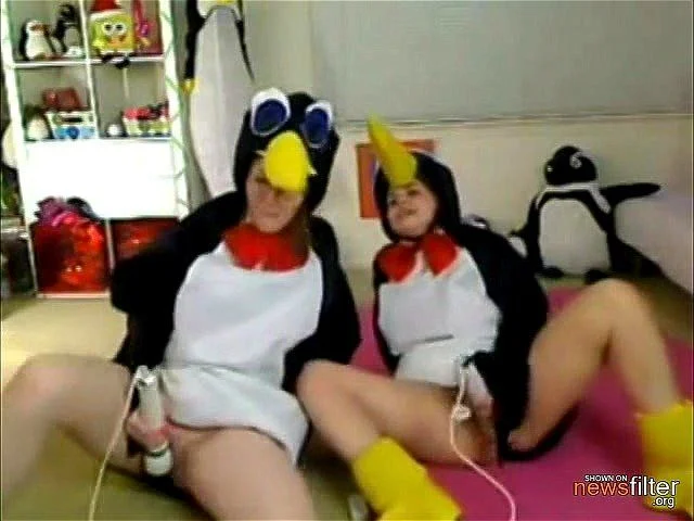 Two webcam chicks dressed in penguin costumes masturbate together