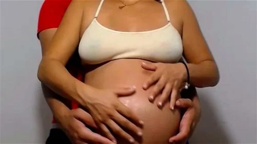 Pregnant Couple rubbing belly