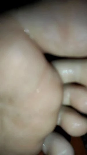 Girl toe spreading with sperm on her feet