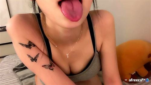 Korean Teen Holds Out Wet Tongue Showing Cleavage