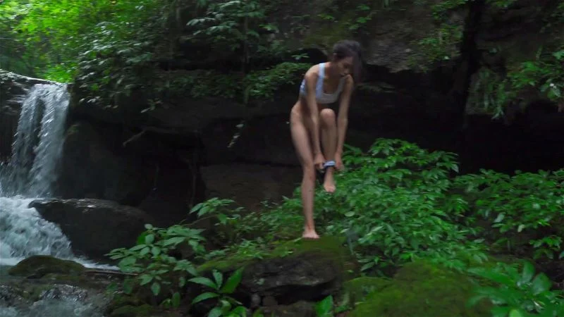 Nude in front of a waterfall