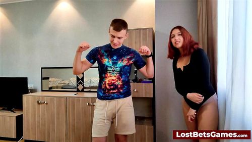Redhead is sucking his hard cock after losing a game of strip darts