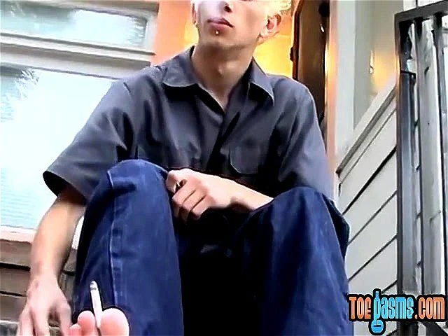 Young punk presents his sexy feet while smoking