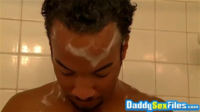 Ebony daddy strokes his dick and uses toys while showering