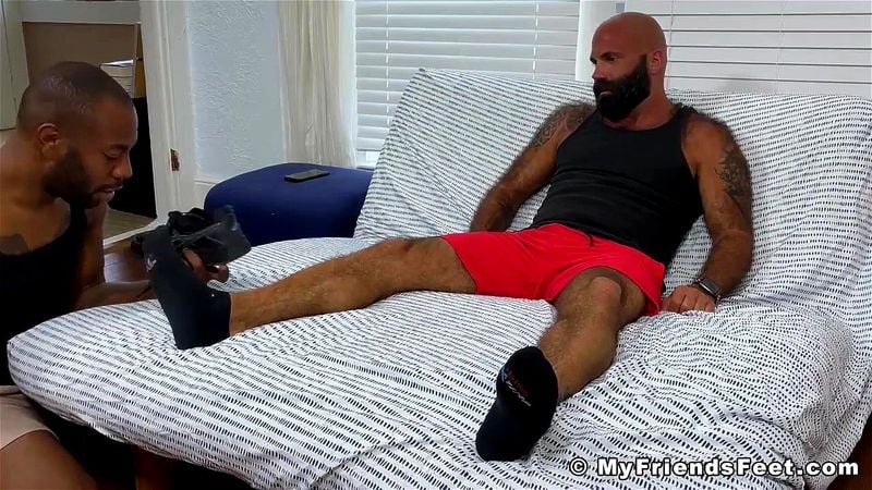 Hairy bearded stud has his feet sucked by a black gay dude Hairy bearded stud has his feet sucked by a black gay dude
