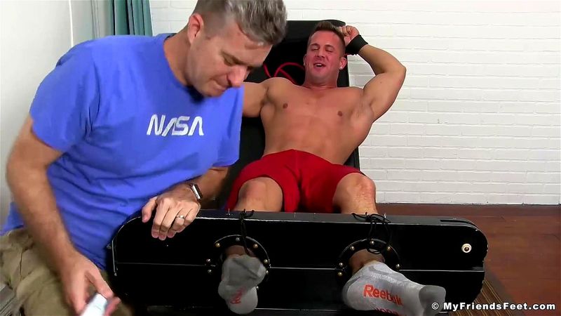 Hot muscle guy gets armpits and feet tickled hard by man