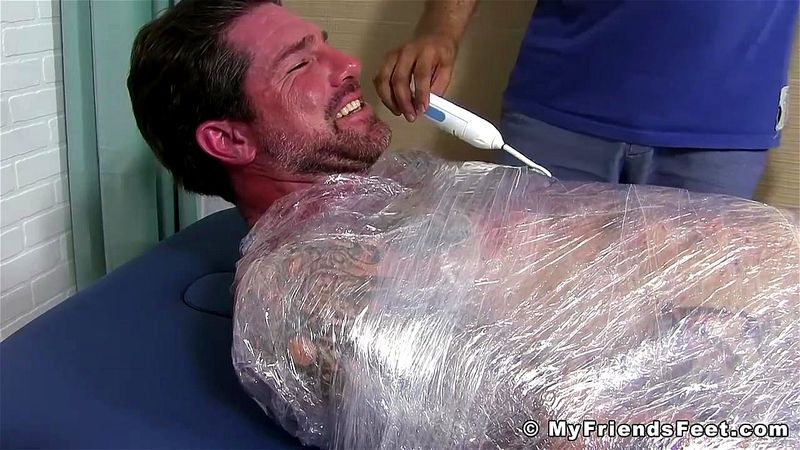 Jock Clint wrapped up to have his feet tickled BDSM style