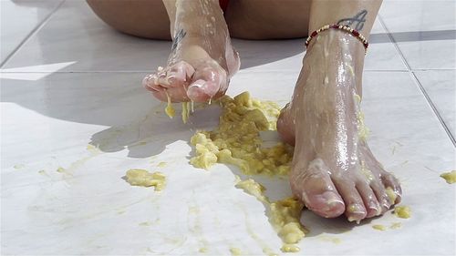 Beautiful wet feet play with a delicious banana