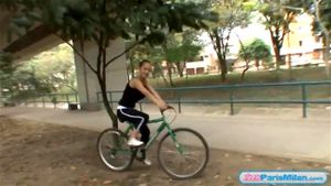 Busty solo teen riding her bike through the park