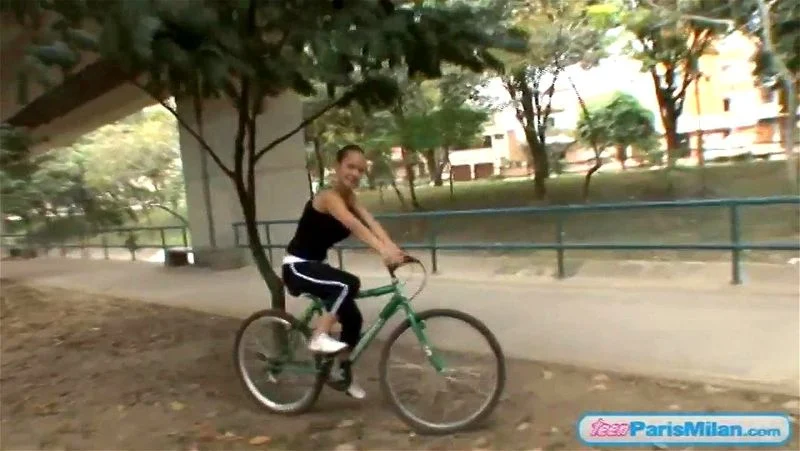 Busty solo teen riding her bike through the park