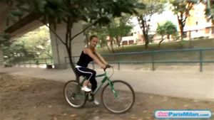 Busty solo teen riding her bike through the park