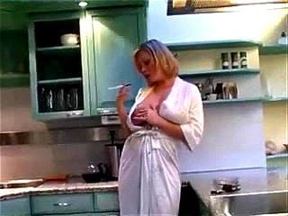 Mature stepmother in the kitchen early morning