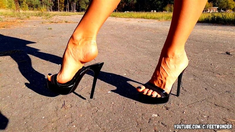 Walking in black high heeled mules