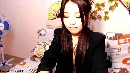 Asian plays with toy webcam