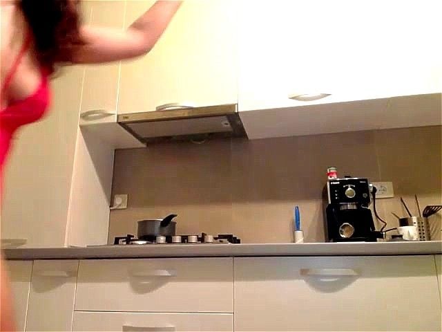 Brunette teases in kitchen Brunette teases in kitchen