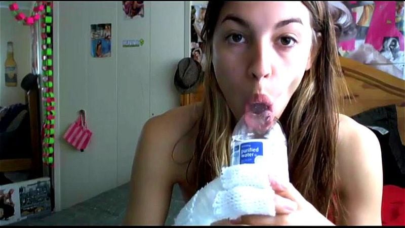 Cute teen girl passionately sucks water bottle