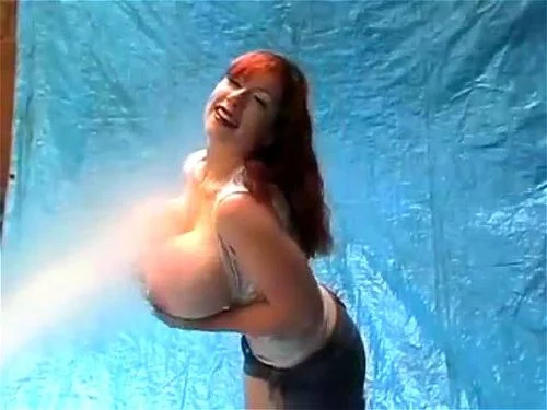 Giant-boobed redhead shakes her tits