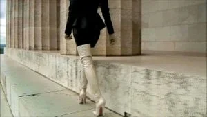 Mistress walking in high white boots