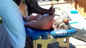 Thick blonde MILF gets erotic rub down from a black man thumbnail