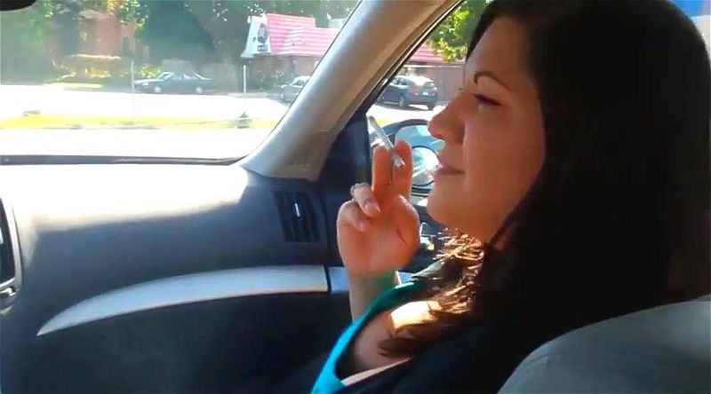 Woman smoking in a car