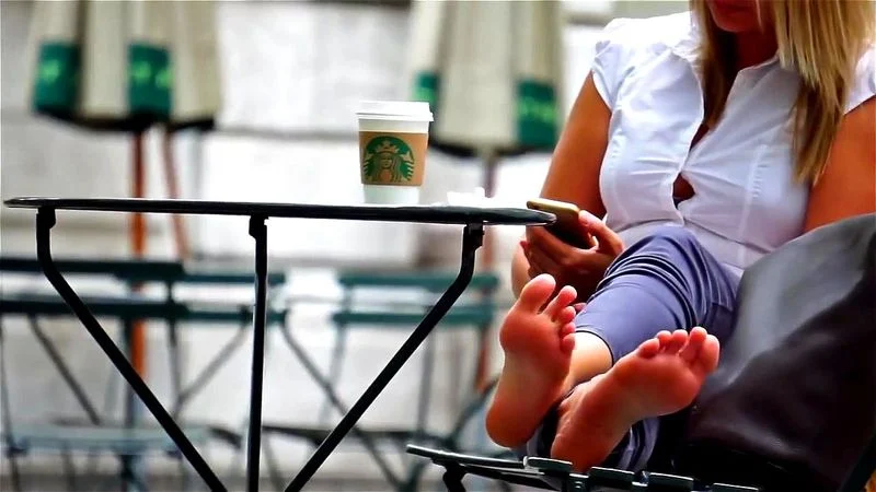 Candid blondes soles on a park bench