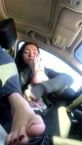 Cutie sucks on her toes in the car