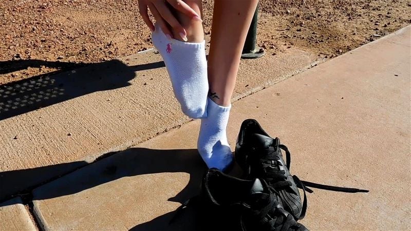 Kaelyn Taking Off Her Black Sneakers And Socks